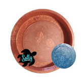 A brown silicone mold with a 4 inch round shape, displayed with indention for cardstock area (a blue piece with a saltwater design) and a label reading 'Salty Creations'. The image shows a copper-colored mold.