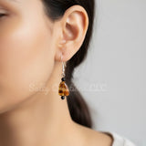 Handmade amber-tone acrylic teardrop earrings with sterling silver hooks by Salty Creations LLC
