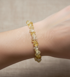 Handmade natural citrine chip stone stretch bracelet worn on a person's wrist.