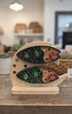 Wooden surf board-shaped puzzle on a stand with decorative elements in a blurred indoor setting