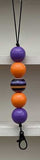 Neon orange and purple bead keychain on a white background