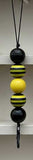 Decorative keychain with black and yellow striped beads on a white background