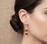 Salty Creations amber glass drop earrings, handcrafted boho jewelry, nickel-free stainless steel earrings for women, earthy amber and cream beaded jewelry.