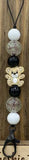 Lanyard with teddy bear charm and beads on a wooden background