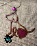 Handmade wooden dog silhouette car charm with a burgundy heart inlay, and marble looking acyrlic bead on burlap background