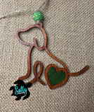 Handmade wooden dog silhouette car charm with a green heart inlay, and green acyrlic bead on burlap background