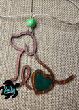 Handmade wooden dog silhouette car charm with a green heart inlay, and green acyrlic bead on burlap background