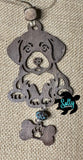 May include: A wooden dog ornament with a brown finish. The dog is sitting  and has a bone tag hanging from its feet. The bone has a paw print cut out of it. 