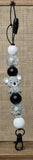 Beaded keychain with a koala charm on a textured surface