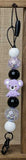 Keychain with beads and a small plush koala toy on a wooden surface
