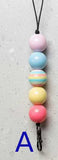 Colorful beaded keychain on a light gray background