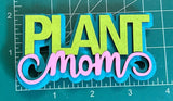 Colorful 'Plant Mom' magnet on a measuring mat.