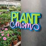Colorful 'Plant Mom' magnet in a greenhouse setting