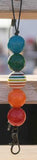 Colorful beaded keychain with a metal clasp on a blurred background