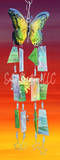 Butterfly-shaped wind chime with colorful hanging elements against a sunset background.