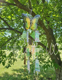 Butterfly-shaped wind chime hanging from a tree