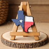 Wooden stand with a Texas-shaped decoration on a wooden base
