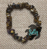 Beaded bracelet with a 'Salty Creations' logo on a textured beige background