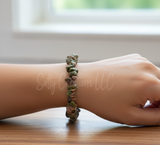 Natural Unakite gemstone chip stretch bracelet on a woman's wrist.