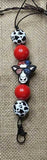 Lanyard with colorful beads featuring animal designs on a textured background