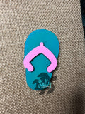 Blue and Pink Wooden flip flop magnet on a burlap background.
