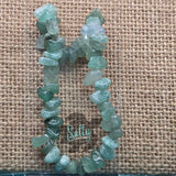 A bracelet made with green aventurine stones, displayed on a textured background and the brand name 'SALTY CREATIONS'.