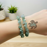 Close-up of a person's wrist wearing a set of two handmade Green Aventurine tumbled stone chip bracelets by Salty Creations LLC.