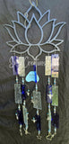 Decorative metal wall art with hanging beads and 'Saff Creations' branding on a dark background.