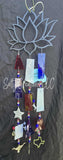 Decorative wind chime with geometric shapes and beads on a dark background
