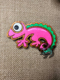 Pink and Green handcrafted wooden chameleon fridge magnets displayed in a grid on a textured background