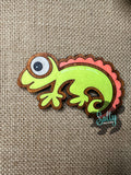 Yellow and Orange handcrafted wooden chameleon fridge magnets displayed in a grid on a textured background